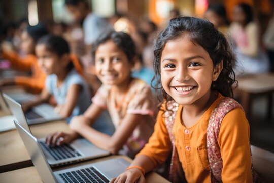Indian school children using laptops in classroom