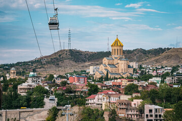 View of the Sameba Cathedral and the Tbilisi ropeway,  in Tbilisi old town, Georgia - obrazy, fototapety, plakaty