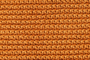 Orange knitted fabric texture background. Top view. Copy, empty space for text