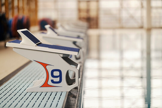 Diving boards and starting blocks on swimming pool.