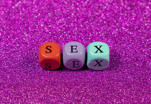 Sex written with wooden cubic beads on a purple background. Image for decoration, ornamental