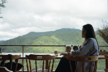 digital nomad concept asian freelancer woman relax and outdoor work at mountain view of coffeeshop