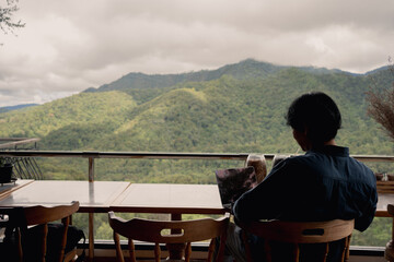 digital nomad concept asian freelancer man use laptop to work at mountain view of coffeeshop