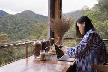 digital nomad concept asian freelancer woman use laptop to work at mountain view of coffeeshop