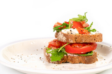 Sandwiches with soft cheese and herbs and tomatoes