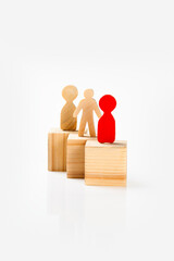 Closeup view of a wooden figure standing on a wooden cube