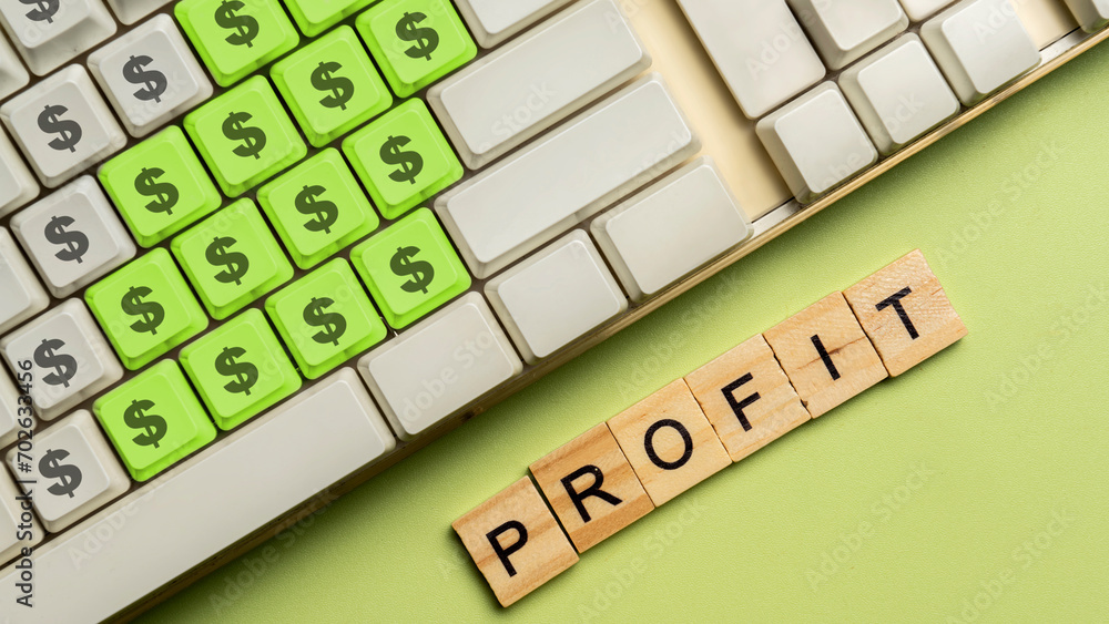 Poster closeup view of computer keyboard and a row of wooden cubes with profit letters