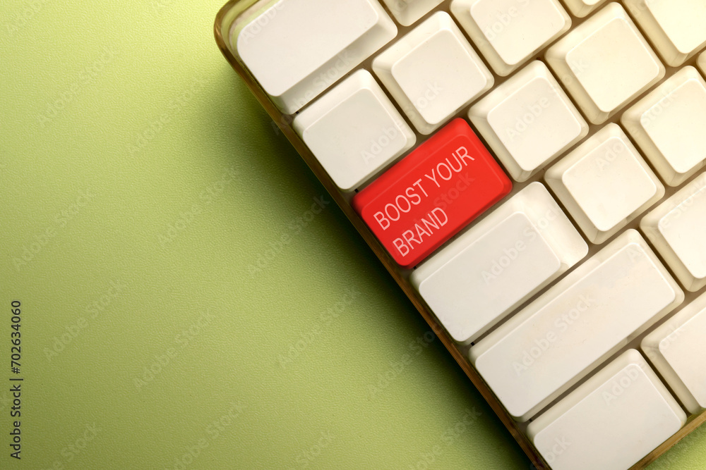 Poster words of boost your brand on the computer keyboard button
