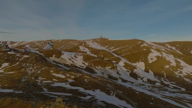 aerial approaching to Costila Radio Relay over carpathian romanian bucegi mountains in snow