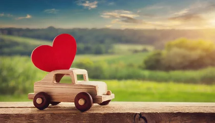 Fototapeten Valentine's day holiday celebration with a wooden toy car and heart shape, countryside © Giuseppe Cammino
