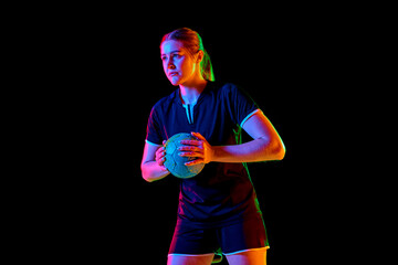Portrait of focused woman, handball player holding ball to make perfect precise serve early in game...