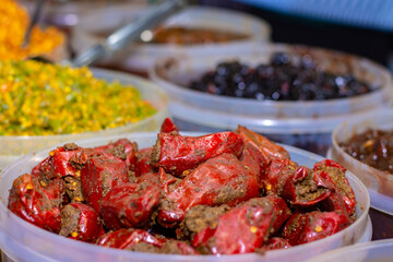 A seller selling delicious Indian Aachar or pickles items at Industrial trade fair in Kolkata, West Bengal, India.