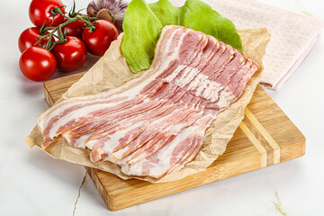 Sliced pork bacon oved board