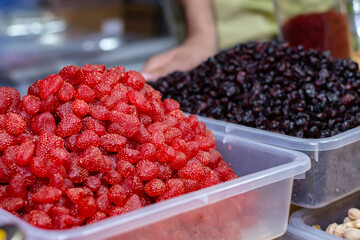A seller selling delicious Afghan dry fruits snacks items at Industrial trade fair in Kolkata, West Bengal, India.