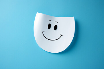 Smile face with paper cut out, in the style of human-canvas integration, back button focus, light blue

