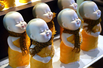 Figurines of Buddhist monks in the store. Souvenirs of Southeast Asia