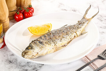 Grilled sea bass fish served lemon