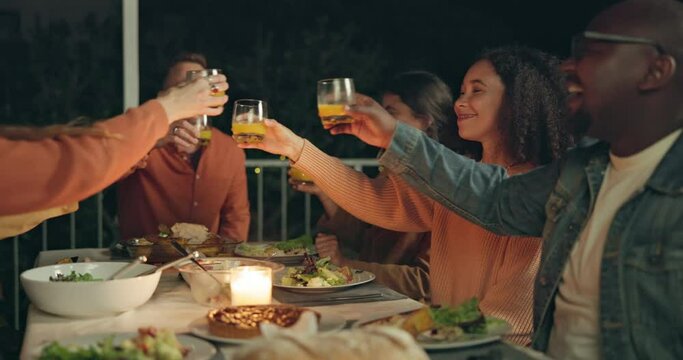 Friends, group toast and dinner on patio, night and conversation with food, new years eve and party. Women, man and outdoor at table with juice, memory or celebration with cheers, diversity or goals