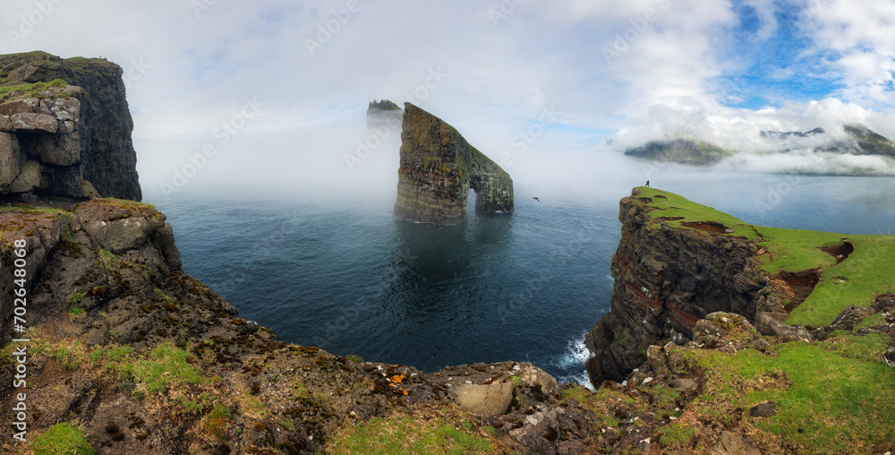 Sticker The beautiful Drangarnir Arch on the Faroe Islands, Atlantic ocean landscape with cliff