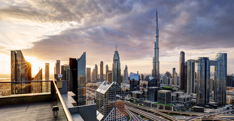 Fototapeta na wymiar Dubai, UAE, January 11 2023: Dramatic sunrise over Dubai skyline panorama with Burj Khalifa and luxury skyscrapers, United Arab Emirates