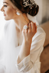 Luxurious wedding barrette on the head of the bride's hairstyle. The morning of the wedding...