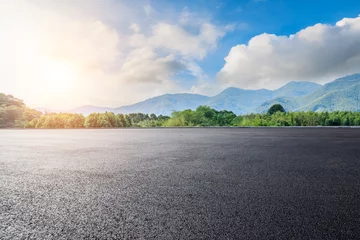  Asphalt road square and green forest with mountain natural landscape under blue sky © ABCDstock