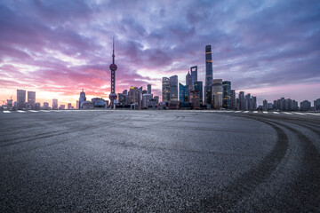 Asphalt road square and modern city commercial buildings at dawn in Shanghai