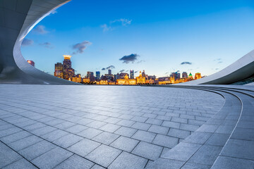 Empty square floor and city skyline with buildings at night in Shanghai