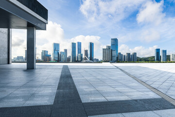 Empty square floor and modern city building scenery under blue sky