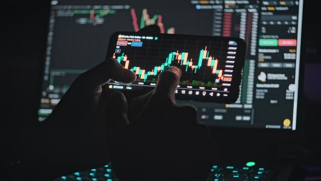 Trader analyzing online BTC price on cryptocurrency graph on smartphone screen. Investor checking crypto market on mobile phone app. Buy Bitcoin. Review the online trading platform application.
