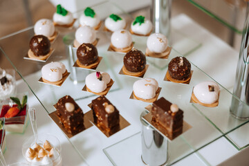 Almond cookies and various sweet cakes for a wedding banquet. A delicious reception, a luxurious ceremony. Table with sweets and desserts. Delicious colorful French desserts on a plate or table.