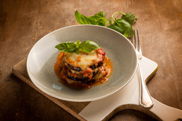 eggplants parmigiana with basil leaves