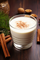 Eggnog or egg milk punch is traditional drink in Christmas season on wood background