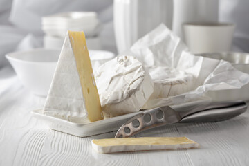 Camembert cheese on a white table.