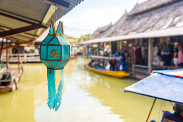 Green lantern in floating open air market with small houses - shops on the pond in Pattaya, Thailand