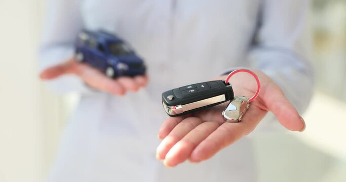 Car buying concept and agent holding key and car