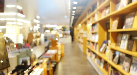Blur background of book shelf store decorated with wood and warm light