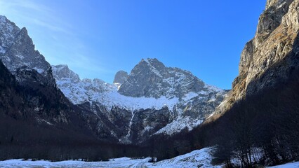 Mountain, snowy peaks against the blue sky