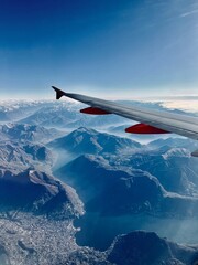 plane wing over alps with snow