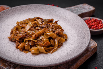 Delicious asian udon dish with vegetables, mushrooms, salt and spices