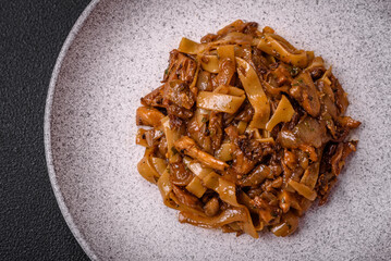 Delicious asian udon dish with vegetables, mushrooms, salt and spices