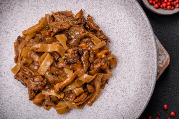 Delicious asian udon dish with vegetables, mushrooms, salt and spices