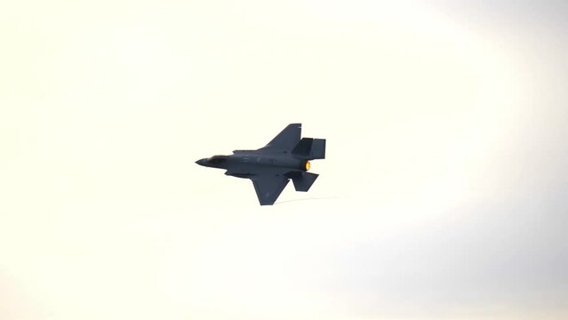 F-35 Fifth-Generation Fighter Jet Igniting Afterburner, Tracking Shot