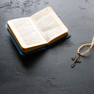 Bible and christian cross on black background