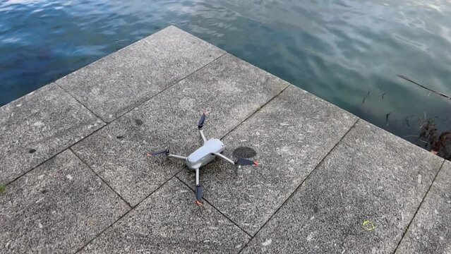 Drone on a ground ready for take off, flying near water