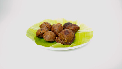Kuzhi Paniyaram, These golden brown dumplings are made from a fermented batter of rice and urad dal, giving them a unique flavor and texture.