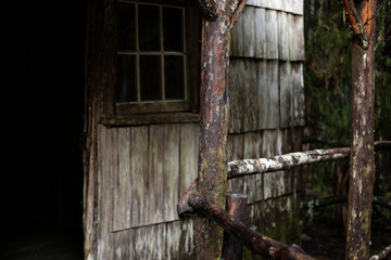 Vintage wooden fence encircles a decaying storage shed