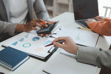 Calculate the numbers according to the report sent to the meeting, They are calculating the taxes they have to pay, They are having a meeting about the company's income and expenses,