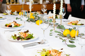 Elegant Dining Table Set for a Gourmet Meal. An elegantly set dining table with gourmet salads,...