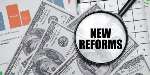 NEW REFORMS word on magnifying glass with dollars and charts